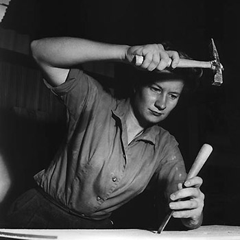 Beverly Willis working with a hammer and chisel.