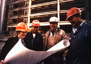 Beverly Willis on job site reviewing blueprints.