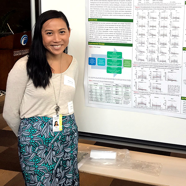 Lauren Ching in front of her research poster.
