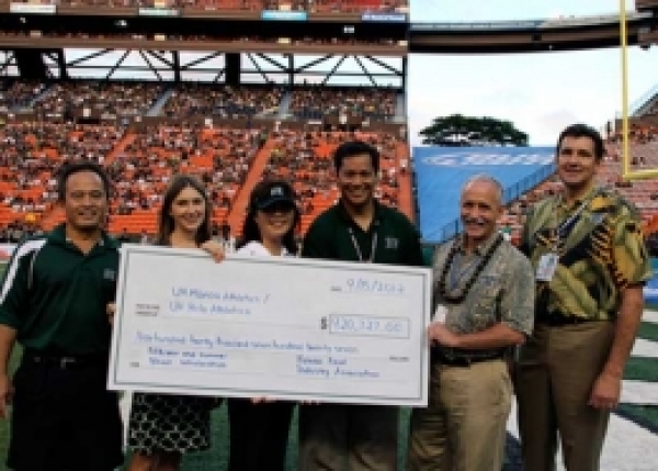 9/15/12 - Photo taken at first time out, during the game against Lamar at the Aloha Stadium. From L-R:  HFIA executive committee member Alan Nakamura; HFIA executive director Lauren Zirbel; HFIA executive committee member Bonny Amemiya; Vincent Baldemor president of ʻAhahui Koa Ānuenue;  UH Mānoa chancellor Tom Apple; and UH Foundation vice president for development Greg Willems
