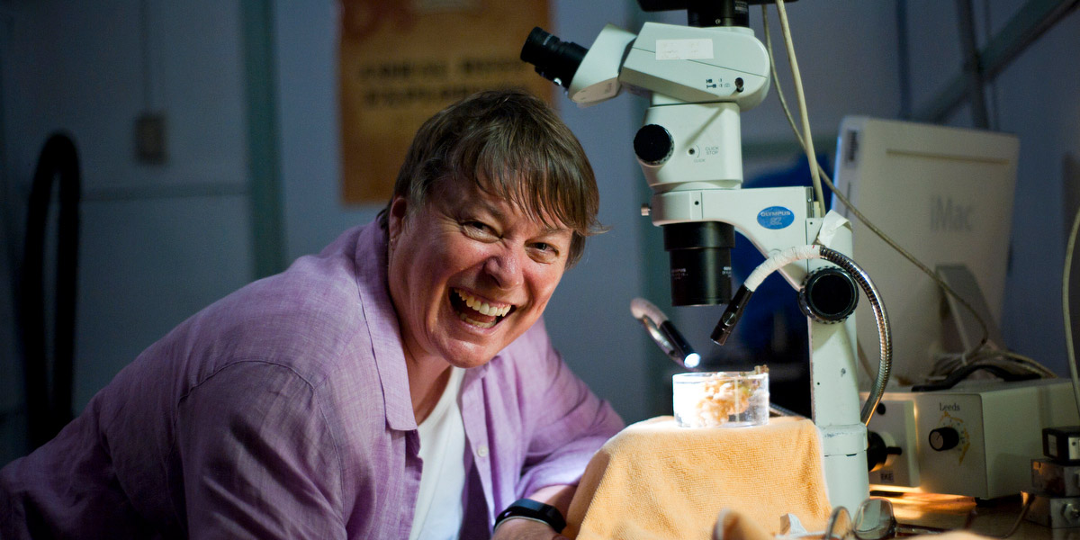 Ruth Gates at a microscope
