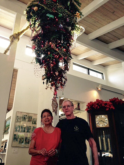 Margaret and David beneath their Christmas tree