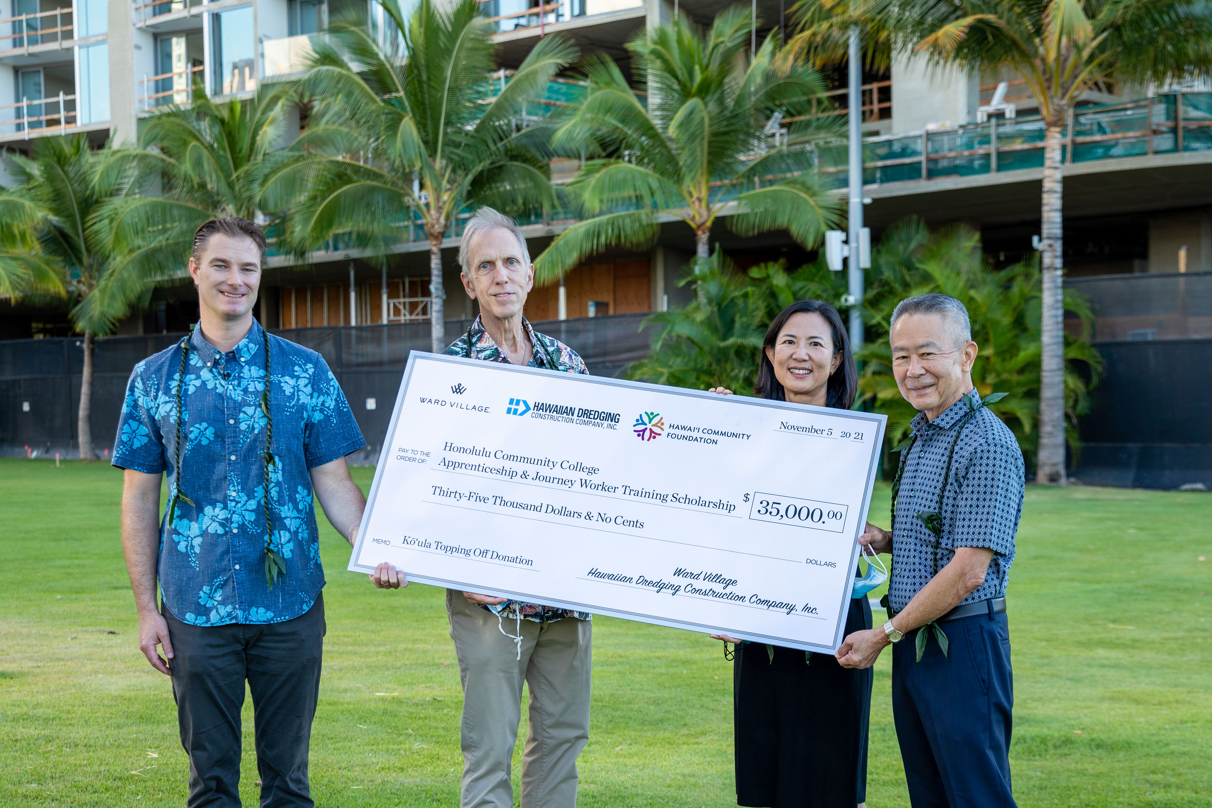 Doug Johnston, Gerry Majkut, Karen C. Lee, Ron Taketa hold a large check for the Honolulu Community College scholarship.