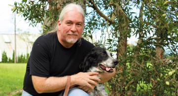 Dr. Philippe Binder of the University of Hawaii, Hilo, with his dog, Peppers.