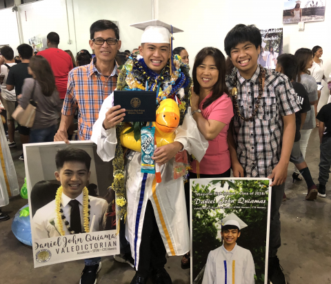 Daniel John Quiamas stands in his cap and gown with his parents and brother at his graduation from Waipahu High School.