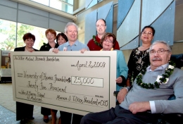 Attending the check presentation are: (left to right) Jeffrie Jones, Director of Development, John A. Burns School of Medicine; Helen Turner, PhD, Chair, Scientific Advisory Board, Tilker Medical Research Foundation; Lynn Tilker, Executive Director, Tilker Medical Research Foundation; Jerris R. Hedges, MD, MS, MMM, Dean, John A. Burns School of Medicine; Richard Allsopp, PhD, John A. Burns School of Medicine; Marcia Tilker; Grace Corpoz; Marvin J. Tilker, President & CEO, Tilker Medical Research Foundation.