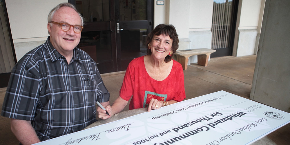 The Lani-Kailua Outdoor Circle donates $6,000 annually for agriculture and environmental scholarships at Windward Community College.  Windward Community College Chancellor Doug Dykstra joins Lani-Kailua Outdoor Circle President Diane Harding as she signs the ceremonial check. 